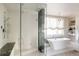 Luxurious bathroom with soaking tub, walk-in shower, and marble accents at 335 Clayton St, Denver, CO 80206