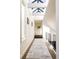 Bright hallway with skylights, hardwood floors, and patterned rug at 335 Clayton St, Denver, CO 80206