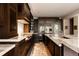 Modern kitchen with dark cabinetry, granite counters, and stainless steel appliances at 335 Clayton St, Denver, CO 80206