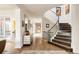 Elegant curved staircase with dark wood treads and wrought iron railing at 335 Clayton St, Denver, CO 80206