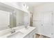 Double vanity sink with an open bathroom door to the glass enclosed shower in the home at 2098 Peachleaf Loop, Castle Rock, CO 80108