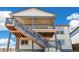 Rear exterior of home showing deck access via wooden staircase at 2098 Peachleaf Loop, Castle Rock, CO 80108