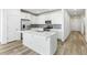 Contemporary kitchen with stainless steel appliances, center island, and a tiled backsplash providing ample counter space at 2098 Peachleaf Loop, Castle Rock, CO 80108