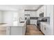 Modern kitchen featuring stainless steel appliances, a central island, and stylish backsplash at 2098 Peachleaf Loop, Castle Rock, CO 80108