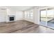 Living room featuring wood floors, fireplace, large windows, and sliding glass doors to the exterior deck at 2098 Peachleaf Loop, Castle Rock, CO 80108