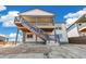 This home boasts a large covered outdoor deck and landscaped backyard on a sunny day at 2098 Peachleaf Loop, Castle Rock, CO 80108