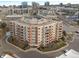 Aerial view of a modern apartment building with ample parking at 4875 S Monaco St # 408, Denver, CO 80237