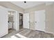 This primary bedroom has a bathroom and kitchen view with updated floors and a ceiling fan at 14308 E Whitaker Pl # 114, Aurora, CO 80015