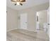This neutral toned primary bedroom has an adjoined bathroom, updated floors and a ceiling fan at 14308 E Whitaker Pl # 114, Aurora, CO 80015