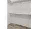Spacious walk-in closet offers ample storage space with shelves and rod for hanging clothes at 14308 E Whitaker Pl # 114, Aurora, CO 80015
