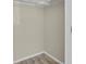 An empty closet with hardwood flooring and a white ceiling rack at 14308 E Whitaker Pl # 114, Aurora, CO 80015