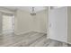 Bright room featuring wood floors and modern chandelier at 14308 E Whitaker Pl # 114, Aurora, CO 80015