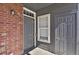 Exterior image of apartment entrance featuring two gray doors and a brick wall at 14308 E Whitaker Pl # 114, Aurora, CO 80015