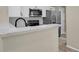 Modern kitchen with white cabinets, stainless steel appliances, and quartz countertops at 14308 E Whitaker Pl # 114, Aurora, CO 80015