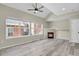 Inviting living room with fireplace, wood floors, ceiling fan, and bright windows at 14308 E Whitaker Pl # 114, Aurora, CO 80015