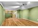 Spacious basement with light-colored wood flooring, light green walls, and access to stairs at 2211 Sherman St, Longmont, CO 80501