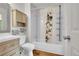 Bright bathroom featuring a shower-over-tub with white tiling, butterfly shower curtain, and a modern vanity at 2211 Sherman St, Longmont, CO 80501
