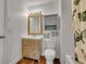 Updated bathroom with wood-like cabinet, mirror, and a shower with a butterfly-themed curtain at 2211 Sherman St, Longmont, CO 80501