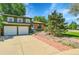 Charming two-story home with a two car garage, well-manicured lawn and mature trees at 2211 Sherman St, Longmont, CO 80501