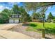 Charming two-story home with a two car garage, well-manicured lawn, mature trees and a green front lamp post at 2211 Sherman St, Longmont, CO 80501