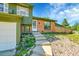 A cozy home front entrance is surrounded by beautiful landscaping leading to the front door at 2211 Sherman St, Longmont, CO 80501