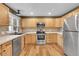 Well-lit kitchen featuring stainless steel appliances, light wood cabinets, and modern countertops at 2211 Sherman St, Longmont, CO 80501