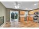 Cozy kitchen featuring wood floors, stainless steel appliances, wood cabinets, and sliding doors to the backyard patio at 2211 Sherman St, Longmont, CO 80501