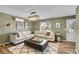 Inviting living room featuring hardwood floors, a modern light fixture, a comfortable sofa, and stylish decor at 2211 Sherman St, Longmont, CO 80501