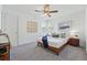 Comfortable bedroom with a ceiling fan, large windows, and modern decor, offering a peaceful retreat at 4740 Milwaukee St, Denver, CO 80216