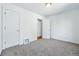 Empty bedroom featuring soft carpet, neutral paint, and white trim around the doors at 4740 Milwaukee St, Denver, CO 80216