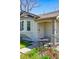 Charming front porch with seating area, wrought iron gate, and neutral paint at 4740 Milwaukee St, Denver, CO 80216