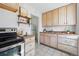 Well-lit kitchen features light wood cabinets, stainless steel appliances, and ample counter space at 4740 Milwaukee St, Denver, CO 80216