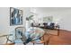 Bright living room featuring a glass-top dining table, wood floors, and comfortable seating area with natural light at 4740 Milwaukee St, Denver, CO 80216