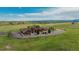 Stone house sits on a green lot, featuring distant mountain views at 15958 Shadow Mountain Ranch Rd, Larkspur, CO 80118