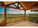 The outdoor balcony has wood railings and supports and a panoramic view of the green fields at 15958 Shadow Mountain Ranch Rd, Larkspur, CO 80118