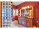 Stylish bathroom featuring unique glass block shower partition, and a vibrant vanity with a vessel sink at 15958 Shadow Mountain Ranch Rd, Larkspur, CO 80118