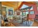 Elegant dining room with a large table, chandelier, and windows offering views of the outdoors at 15958 Shadow Mountain Ranch Rd, Larkspur, CO 80118