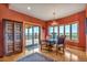 Cozy dining room featuring custom doors to outdoor deck, and unique furnishings at 15958 Shadow Mountain Ranch Rd, Larkspur, CO 80118