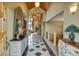 Inviting entryway with unique decor, tile flooring, and a view into the expansive living area at 15958 Shadow Mountain Ranch Rd, Larkspur, CO 80118