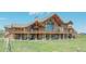Magnificent exterior highlighting a spacious deck, stone facade, and timber accents at 15958 Shadow Mountain Ranch Rd, Larkspur, CO 80118