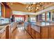 Well-equipped kitchen with stainless steel appliances, an island, and seamless flow to the dining area at 15958 Shadow Mountain Ranch Rd, Larkspur, CO 80118