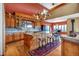 Gourmet kitchen featuring custom cabinetry, granite countertops, an oversized island, and high-end appliances at 15958 Shadow Mountain Ranch Rd, Larkspur, CO 80118