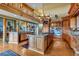 Open-concept kitchen with a central island, stainless steel appliances, and custom wood cabinetry at 15958 Shadow Mountain Ranch Rd, Larkspur, CO 80118
