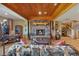 This finished living space has a stone fireplace, wooden floors and ample natural light at 15958 Shadow Mountain Ranch Rd, Larkspur, CO 80118