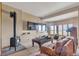 Cozy living room with wood-burning stove, plush seating, and plenty of natural light from large windows at 15958 Shadow Mountain Ranch Rd, Larkspur, CO 80118