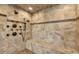 The shower features a built-in bench and a mosaic accent stripe, adding luxury and style at 15958 Shadow Mountain Ranch Rd, Larkspur, CO 80118