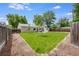 Expansive backyard featuring a manicured lawn, privacy fence, and a stone patio perfect for relaxation at 3278 S Forest St, Denver, CO 80222