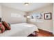 Bedroom with a window, hardwood floors, and bright natural light at 3278 S Forest St, Denver, CO 80222