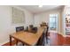 Charming dining area featuring a dining table and artwork with access to the bathroom and living room at 3278 S Forest St, Denver, CO 80222