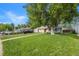 Charming home exterior featuring a well-kept front lawn, mature trees, and a welcoming facade at 3278 S Forest St, Denver, CO 80222